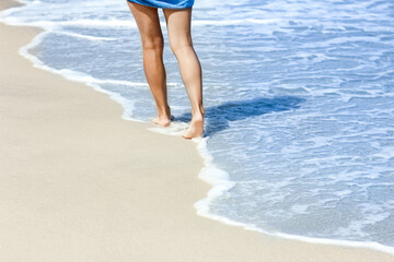 Wall Mural - A Feet and footprints by the seashore in nature travel vacation background