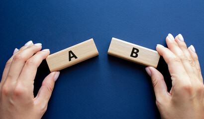 Plan A and Plan B symbol. Concept word Plan A and Plan B on wooden blocks. Businessman hand. Beautiful deep blue background. Plan A and Plan B concept. Copy space