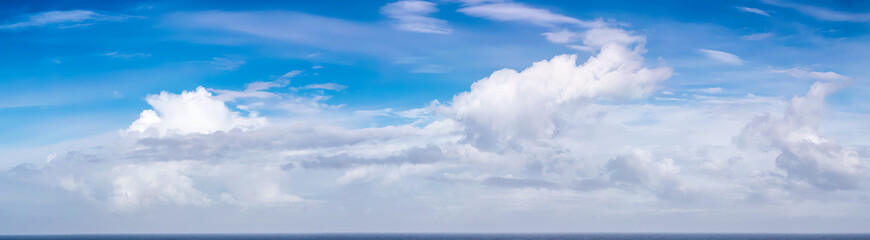 Wall Mural - Cloudy Blue Colorful Sky over North Atlantic Ocean. Cloudscape Nature Background.