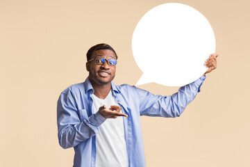 Wall Mural - Confused African American Man Holding Blank Speech Bubble Showing What He Really Thinks Standing Over Yellow Background. Mockup