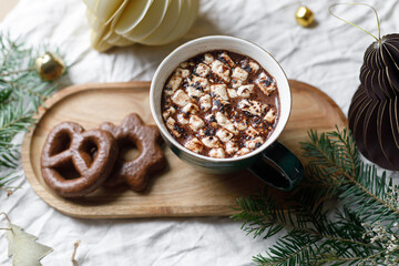 Wall Mural - Christmas background. Cup of hot chocolate with marshmallow and cookies, christmas ornaments and gift on wooden tray top view. Merry Christmas. Winter hygge