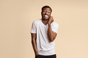 Aufkleber - Afro Guy Laughing Talking On Cellphone Standing Over Yellow Studio Background. Empty Space For Text