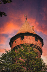 Wall Mural - Haunted abandoned tower on the sunset sky background