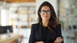 © KKC Studio - Confident Female Manager with Arms Crossed in Sleek Office Setting