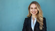 © Oleksandr - Photo of woman with blonde hair in a business suit smiling at the camera against a blue background