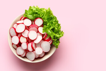 Wall Mural - Bowl with sliced radish and lettuce on pink background