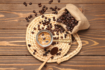 Wall Mural - Jezve with coffee and bag of beans on wooden background