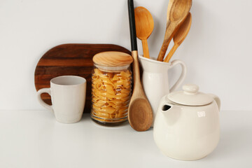 Poster - Composition with teapot, cup and different items on white table