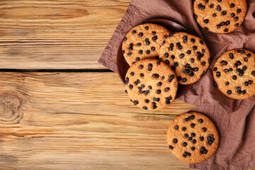 Wall Mural - Tasty cookies with chocolate chips on wooden background