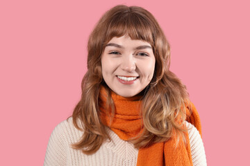 Sticker - Smiling young woman in warm scarf on pink background, closeup