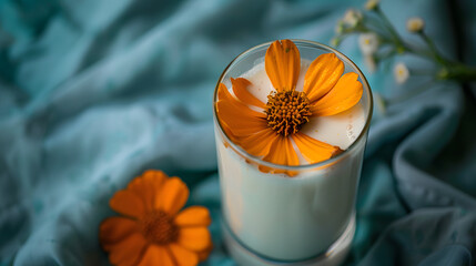 Wall Mural - A glass of milk with a flower in it