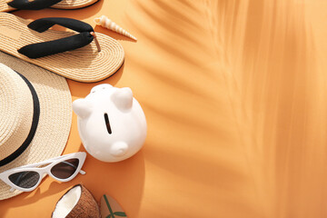 Wall Mural - Piggy bank, sunglasses, hat, flip-flops and coconut on beige background