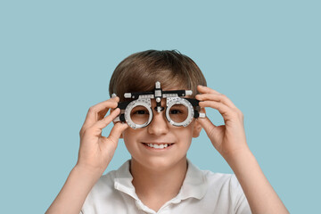 Poster - Little boy in optical trial frame on blue background