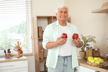 Poster - Mature man with apples in kitchen