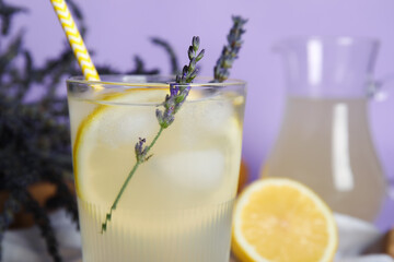 Wall Mural - Glass of cold lavender lemonade on color background, closeup