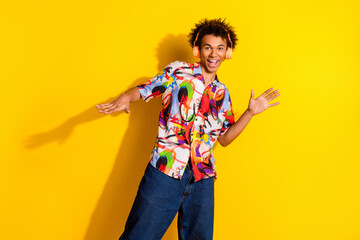 Sticker - Portrait of nice funky young man dance headphones wear shirt isolated on vibrant yellow color background