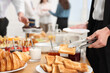 © New Africa - Coworkers having coffee break in office, closeup