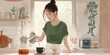 © Natalia - A woman is making coffee in the kitchen. AI.