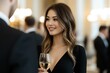 © Alpha - Young Asian woman in a sleek black dress, confidently engaging with others at a glamorous networking event in a grand ballroom