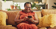 © AzeemudDeen/peopleimages.com - Home, senior woman and smartphone with typing, connection and chatting in living room. African person, apartment and lady with cellphone, mobile user and internet with message, social media and text