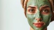 © tanayoch - A woman with a green face mask enjoys a relaxing skincare routine, promoting healthy and glowing skin. Spa and wellness beauty treatment.