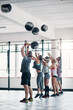 © BestLens/peopleimages.com - Fitness, endurance and medicine ball with group in gym and class for workout, health and sports exercise. People, strong and weights with athlete bodybuilder for muscle, coaching and training