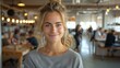 © Рудой Максим - Young Woman Smiling in Modern Workplace During Daytime With Busy Colleagues Around