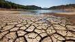 © THESUN - A lake with significantly lower water levels, surrounded by dry, cracked earth, indicating severe drought.