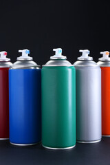 Canvas Print - Many spray paint cans on dark gray background