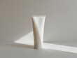 © pavlofox - White Squeeze Tube of Cream in Sunlight on Minimalist Surface