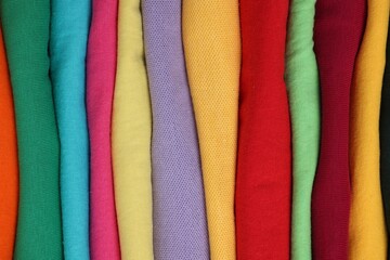 Wall Mural - Stack of clean colorful t-shirts as background, closeup