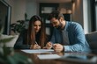 © D3ll.Maccaroni - Couple Signing Important Documents: A young couple, sitting at a table in a cozy living room, signs important documents. Their expressions convey focus and commitment, suggesting a significant step in