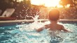 © arhendrix - Young boy playing and splashing in the swimming pool during a sunny day, enjoying summer vacation, backlight sun creating a warm atmosphere.