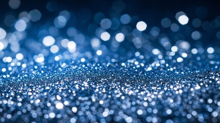 Poster - Silver glitter scatters across a deep blue surface, creating a mesmerizing sparkling effect, perfect for festive occasions or special celebrations
