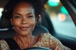 © RaptorWoman - A confident woman smiling while driving her car, highlighting independence and contentment.