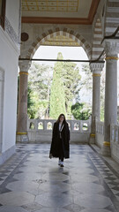 Wall Mural - Young woman touring the historic topkapi palace in istanbul, a symbol of ottoman architecture