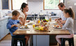 © peopleimages.com - Happy family, kitchen table and eating breakfast in morning for nutrition, food and meal as healthy diet. Parents, children and house with excited, hungry and together on weekend for bonding in home