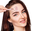 © Galaxy_love_design - Young woman using pink quartz gua sha roller for face.