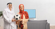© Ljupco Smokovski - Mature muslim man and a young woman holding a football