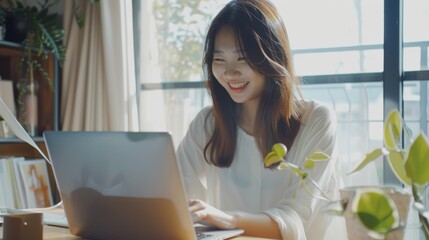 Sticker - A young woman, surrounded by plants, smiles brightly while working on her laptop in a sunlit room, radiating a sense of happiness and productivity.