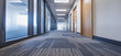 © BraveSpirit - Long Office Corridor With Large Windows and Modern Carpeting Bathed in Natural Light