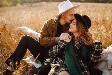 Happy young couple in love enjoy pleasant walk walking in autumn park holding hands communicate talking smiling. Romantic date in nature romance relationships concept.