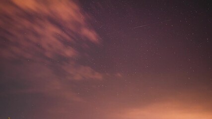 Wall Mural - Bright Dramatic Trails Of Stars And Meteors. Sky In Different Colors. From Dusk Till Dawn. Misty Night Time. Fast Running Clouds Timelapse. Amazing Night Starry Sky Transition To Bold Morning Sky