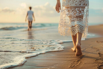 Wall Mural - Woman Walking on the Beach at Sunset.