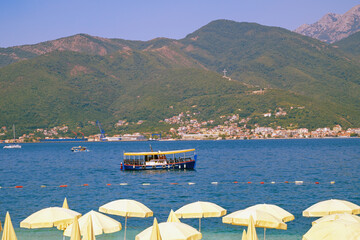 Wall Mural - Summer beach vacation. Beautiful sunny Mediterranean landscape. Montenegro, Adriatic Sea, view of Bay of Kotor near Tivat city