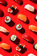 Wall Mural - pattern of variety of sushis on red background. Top view