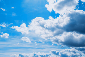 Dramatic blue sky background. Picturesque colorful clouds lit by sunlight