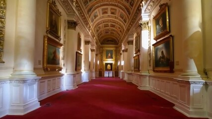 An elegant art gallery corridor with stunning paintings and ornate architecture