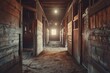 © NASH - View inside rustic barn with horse stalls illuminated tunnel at end
