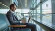 © LookChin AI - Businessman Working on Laptop at Airport Terminal with Clear Space